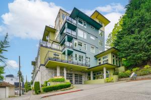 a tall building with yellow and green at 1 Mi to Dtwn Seattle Condo with Garage Parking in Seattle