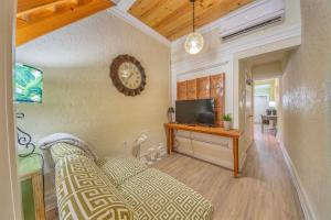 a living room with a couch and a clock on the wall at Stroll Into Town Cozy Apartment in Kilmarnock in Kilmarnock