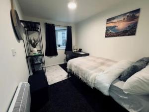 a bedroom with a bed and a television in it at 248 Halls in Middlesbrough