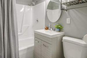 a white bathroom with a sink and a mirror at 1 Mi to Lake Erie Family-Friendly Angola Home! in Angola +19 photos