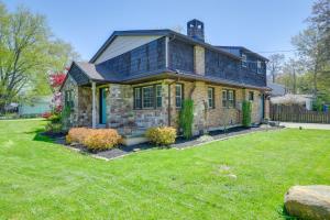 a brick house with a green yard at 1 Mi to Lake Erie Family-Friendly Angola Home! in Angola