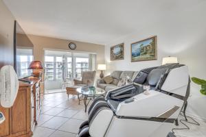 a living room with a patient in a hospital room at 9 Mi to Pompano Beach Condo with Resort Perks! in Lauderdale Lakes
