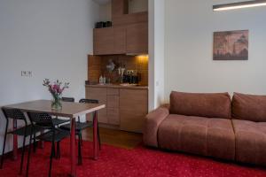 a living room with a couch and a table at Agneta Apartamentai in Druskininkai