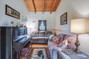 a living room with a couch and a piano at Near State Parks Countryside Cottage in Wellsboro in Wellsboro