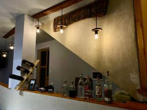 a bar with bottles of wine on a counter at Velaj Guest House in Cfir