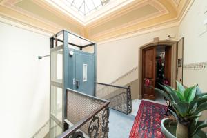 a room with a blue door and a staircase at Roby's Boutique Rooms - Luxury B&B in Catania