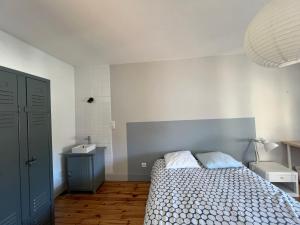 ein kleines Schlafzimmer mit einem Bett und einem blauen Schrank in der Unterkunft Chambres indépendantes Centre Ville Yssingeaux in Yssingeaux