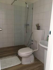 a bathroom with a toilet and a sink at Alana's loft in Praia +2 photos