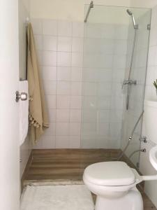 a bathroom with a toilet and a shower and a sink at Alana's loft in Praia