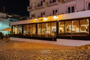 a store front of a building at night at Hotel Baltum in Albufeira