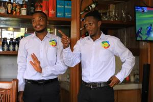 two men standing next to each other in a bar at Dancourt Funfair Hotel in Thika +83 photos