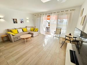 a living room with a couch and a table at Beautiful Sunset Apartment in Puerto de Santiago