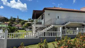 a white house with a white fence and stairs at Stonetrail in Arnos Vale