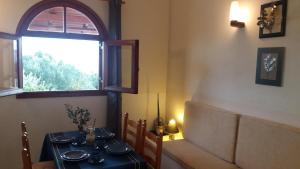 a dining room with a table and a window at Elia Houses in Koutsounari