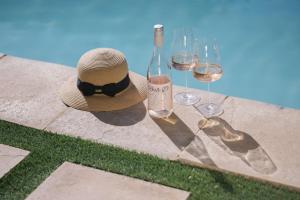 a hat and glasses of wine sitting on a table at Doran Vineyards in Paarl