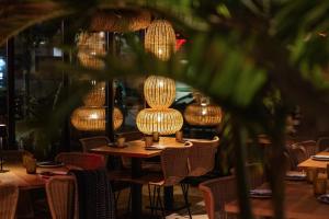 a table in a restaurant with lights on it at Hotel Baltum in Albufeira