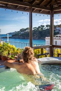 a man in a jacuzzi in a swimming pool at La Muntanya in Llafranc +92 photos