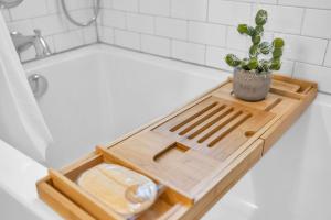 a cutting board sitting on top of a bath tub at Historic West End Guest Studio Suite by SkyRun Nashville in Nashville