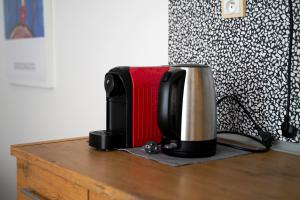 a coffee maker sitting on top of a wooden table at K-HAUS - English Speaking, Contactless-Self Check In Accomodation in Děčín