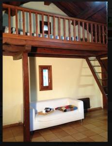 a living room with a white couch under a staircase at La era de Satue in Fanlo del Valle de Vío