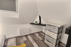 a small room with a shelf and a dresser at Les Apparts du Pont Vert - lit double - WiFi - tout inclus - 4 in Troyes