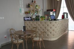 a restaurant with a table and chairs and a bar at Hotel Heaven in Amara