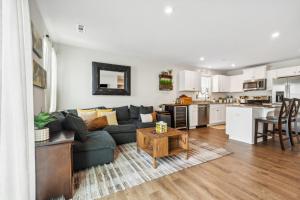 a living room and kitchen with a couch and a table at Stylish Vibe 2 Bed 2 Bath Nashville Home 30 or more Days by SkyRun Nashville in Nashville +47 photos