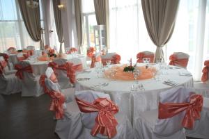 a room with white tables and chairs with red bows at Hotel Heaven in Amara