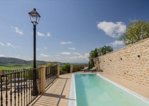 a house with a swimming pool and a street light at Hotel Boutique Mirador de Deyo Adults Only in Villamayor de Monjardín