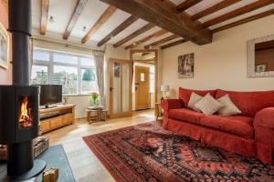 ベバリーにあるHigh Barn 6 bedroomsのリビングルーム(赤いソファ、暖炉付)