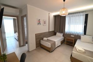 a hotel room with a bed and a couch at SKYLINE Fine Living in Nei Poroi