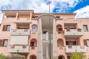 an apartment building with balconies and a pole at casa illaria in Olbia
