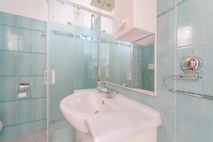 a bathroom with a sink and a mirror and a shower at casa illaria in Olbia +8 photos
