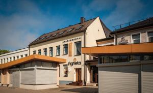 a building with two garage doors in front of it at Agneta Apartamentai in Druskininkai
