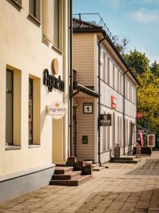 a building with a sign on the side of it at Agneta Apartamentai in Druskininkai