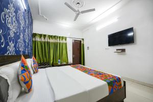 a bedroom with a bed and a flat screen tv at FabExpress Diamond Sec 45 in Chandīgarh