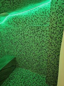 a shower with green lights in a bathroom at Florence Colonna Spa in Florence