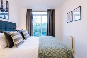 コベントリーにあるParadise Oasis - 2Bed Gem, Free Parking & Netflix, Near Centreの大きな窓のあるベッドのある寝室