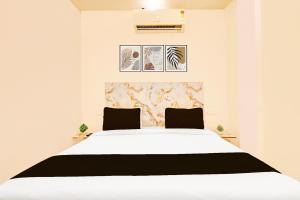 a bedroom with a large white bed with two pillows at The Krishna's Bliss in Ghaziabad +24 photos