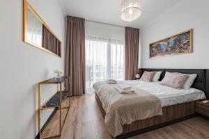 a bedroom with a bed and a large window at Sol Marina by Comfort Apartments in Wiślinka