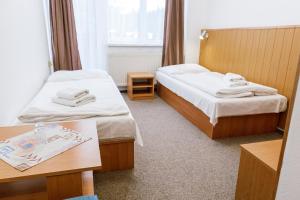 Postel nebo postele na pokoji v ubytování Hotel Tatrawest