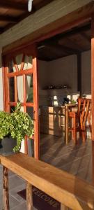 a room with a table and a bench with a potted plant at Ancestral Cabaña in San Vicente