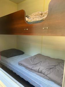 two beds in a room with a bunk bed at OPHEA 4 personnes in Limeuil +6 photos