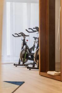 two exercise bikes parked in a room at Grand Hôtel Du Nord in Vesoul
