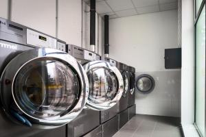 a row of washing machines in a laundrette at CIS Nantes Le Spot in Nantes