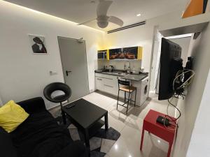 a living room with a couch and a kitchen at Sea pearl tower in Netanya