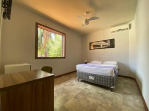 Cama ou camas em um quarto em Wafeh Pampulha Suítes