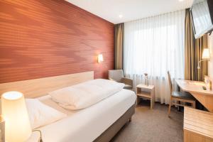 Postel nebo postele na pokoji v ubytování Hotel Rennschuh