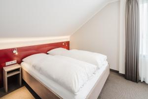 Postel nebo postele na pokoji v ubytování Hotel Rennschuh