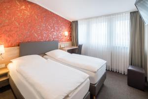 Postel nebo postele na pokoji v ubytování Hotel Rennschuh